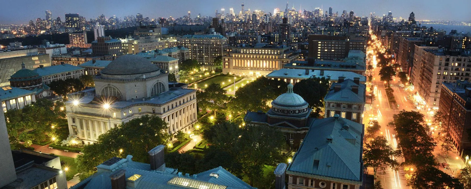 Manhattan skyline at night with Columbia's Morningside Heights campus in the foreground